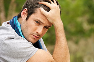 Man with a thoughtful expression reflecting Ethembas professional care for mens health